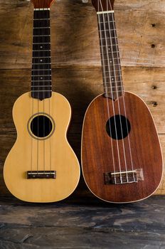 ukulele against a wooden background.