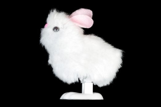 Close-up of a white fluffy bunny toy, side view.