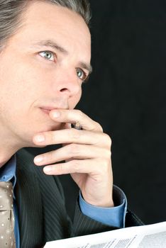 Close-up of a thoughtful businessman looking off camera.