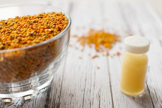 raw organic bee pollen over wooden board