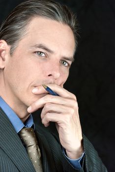 Close-up of a thoughtful businessman looking to camera.