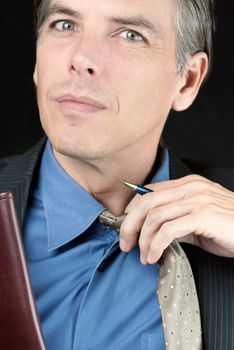 Close-up of a stressed businessman adjusting his tie.