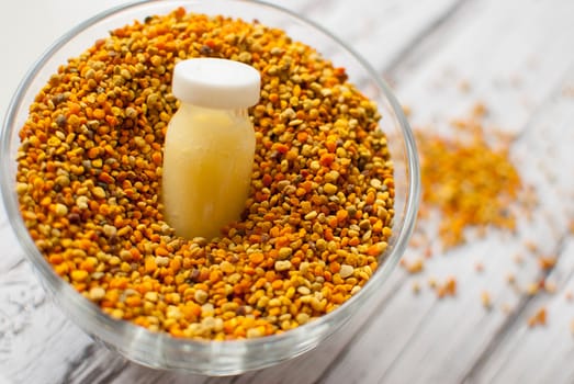 raw organic bee pollen over wooden board