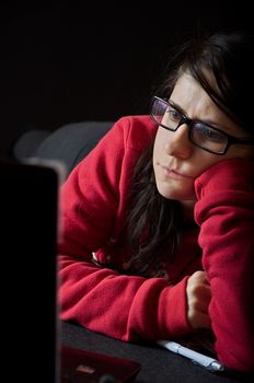 Girl in red sweater using notebook