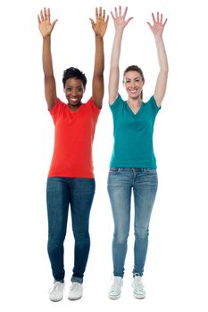 Pretty young woman raising their arms in enjoyment