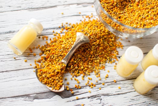 raw organic bee pollen over wooden board