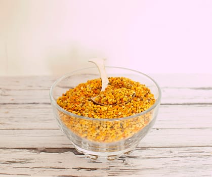 raw organic bee pollen over wooden board