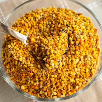 raw organic bee pollen over wooden board