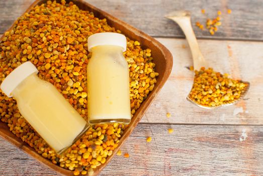 raw organic bee pollen over wooden board