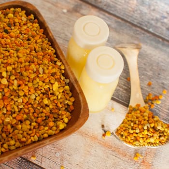 raw organic bee pollen over wooden board