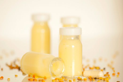 raw organic royal jelly in a small bottle