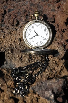 Time Concept Classic Vintage Pocket Clock on the Volcanic Rocks