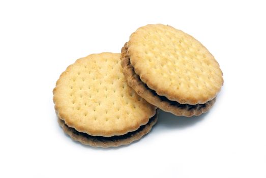 Two biscuits isolated with cocoa cream on a white background.