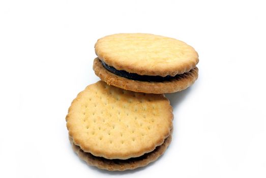 Two biscuits with cocoa filling on white