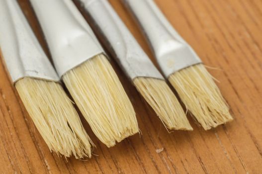 New Wooden Different Paintbrush Set Texture over a Colored Background