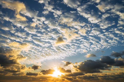 Sunrise with sun rays and clouds