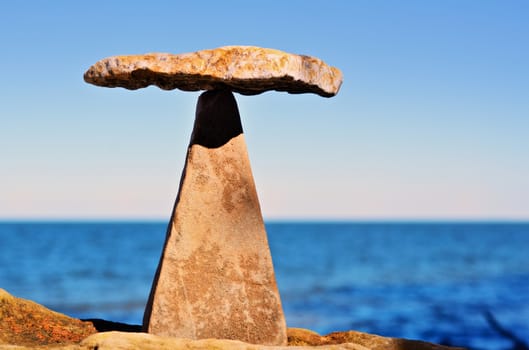 Balancing of pebbles on the top of triangle stone