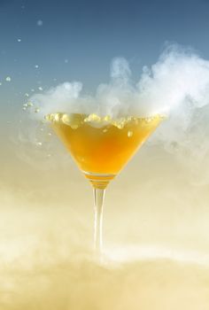 Vertical photo of a splash colored drink with smoke