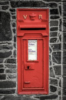 Vintage Red British Post Box In Black And White Stone Wall