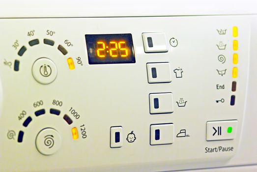 White washing machine control panel, close up image