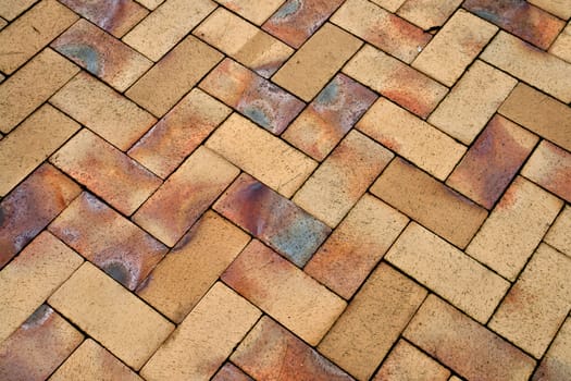 Details of different tones of brown geometric shaped stone garden tiles floor