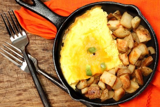 Denver Omelette and Ranch Potatoes in Cast Iron Skillet at Table
