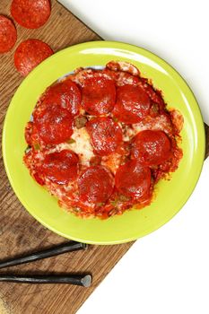 Microwaved Frozen Pizza in Plate on Table