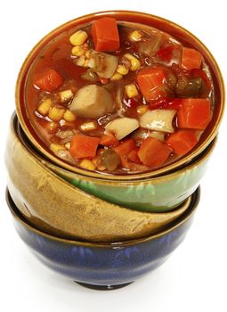 Colorful Asian Ceramic Bowls Stacked On Each Other Over White filled with Maryland Crab Stew