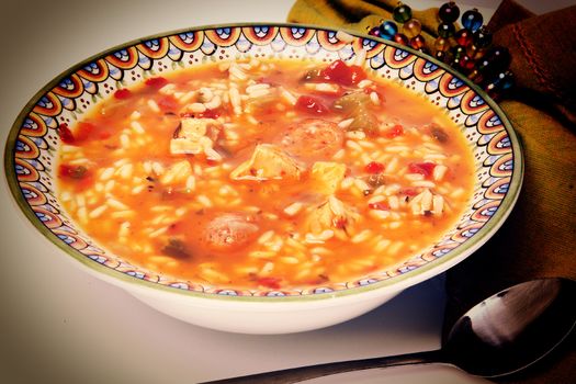 Cajun Chicken and Sausage Gumbo in a bowl with spoon and napkin.