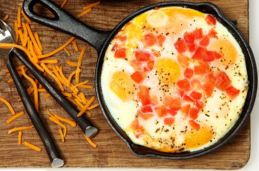 Skillet Baked Eggs with Tomato and Pepper on Table