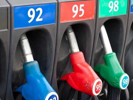 Three gas pump nozzles in service station