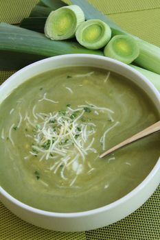 bowl with soup and cheese, and fresh leek
