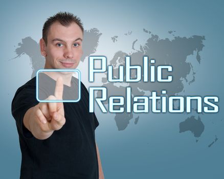 Young man press digital Public Relations button on interface in front of him