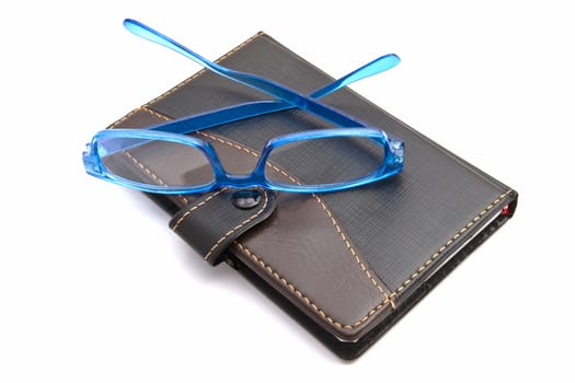 notebook and glasses isolated on white background 