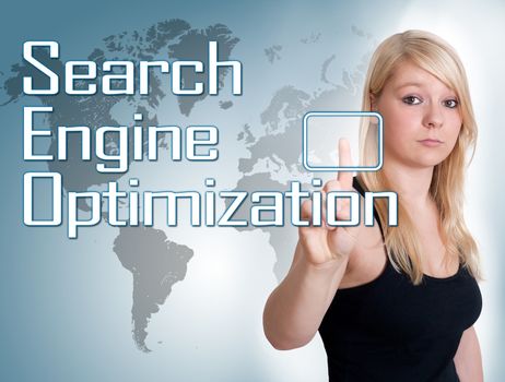 Young woman press digital Search Engine Optimization button on interface in front of her