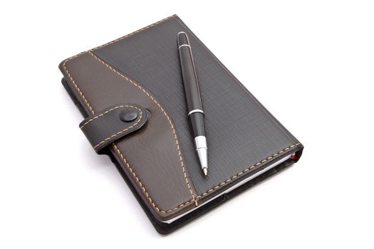 Notebook and pen isolated on white background