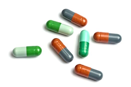 A few colorful capsules isolated on white background 
