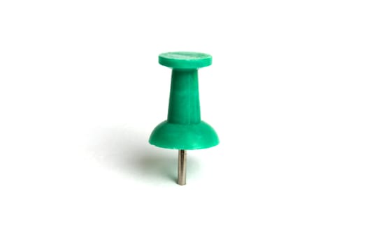Green push pin isolated on white background 
