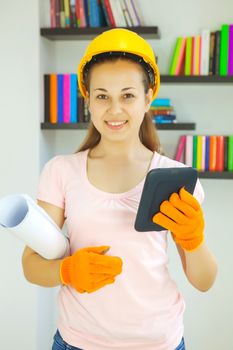 Young attractive lady architect with blueprints