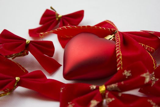 Heart shaped decoration with ribbons around it.