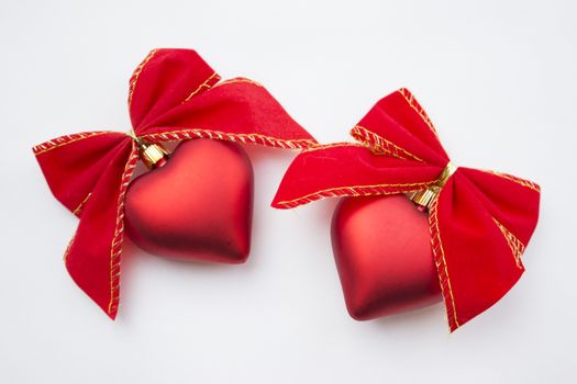 Heart shaped decoration with ribbons around it.