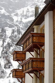 Close up on wooden balconies of a chalet at Loeche les bains in winter, Switzerland