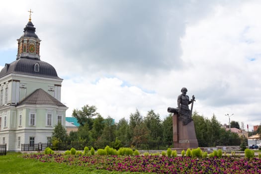 White and green orthodox church and monument
