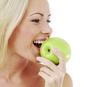 Beautiful  young woman bites a green apple, isolated on white
