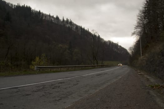 Car on a mountain road at dusk