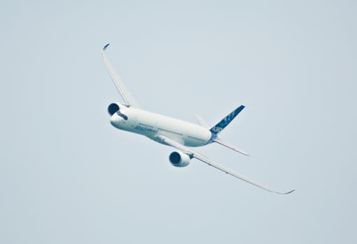 SINGAPORE - FEBRUARY 11: Airbus A350 XWB prototype 003 flying during Singapore Airshow, Changi Exhibition Centre in Singapore on February 11, 2014.