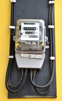 watthour meter on yellow wall