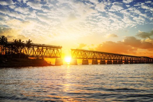 Beautiful colorful sunset or sunrise with broken bridge and cloudy sky. Taken at Bahia Honda state park in the Florida Keys, near famous tourist destination of Key West. 