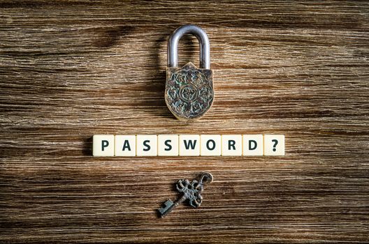 Old vintage padlock and key on wooden texture with password sign