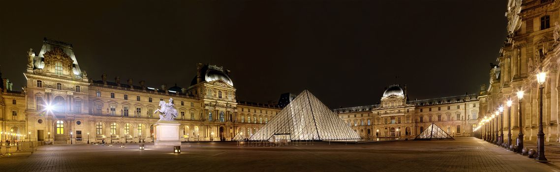 PARIS-APRIL 4: Panoramic view of Louvre Art Museum at night. The Louvre is the biggest Museum in Paris displayed over 60,000 square meters of exhibition space, on April 4, 2013 in Paris, France.